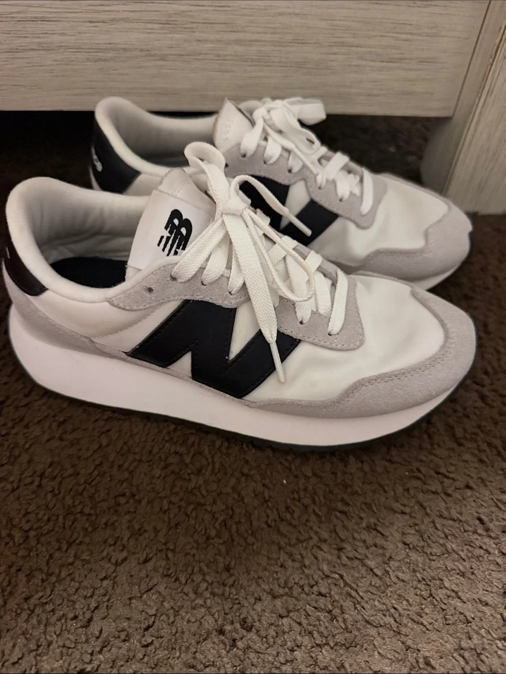 New Balance White Sneakers with Black Logo and Gray Suede